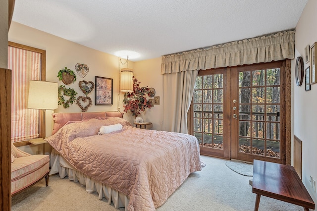 carpeted bedroom featuring a textured ceiling and access to outside