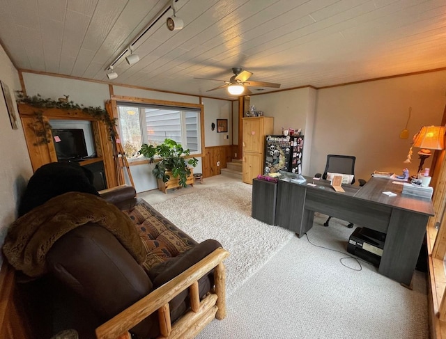 office space with ceiling fan, carpet, track lighting, and wooden walls