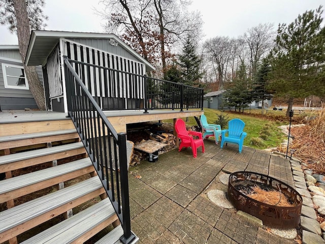 view of patio / terrace with a deck and an outdoor fire pit