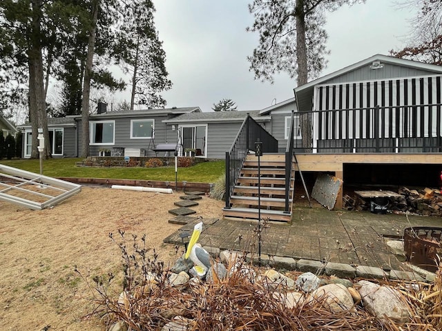 back of property featuring a wooden deck