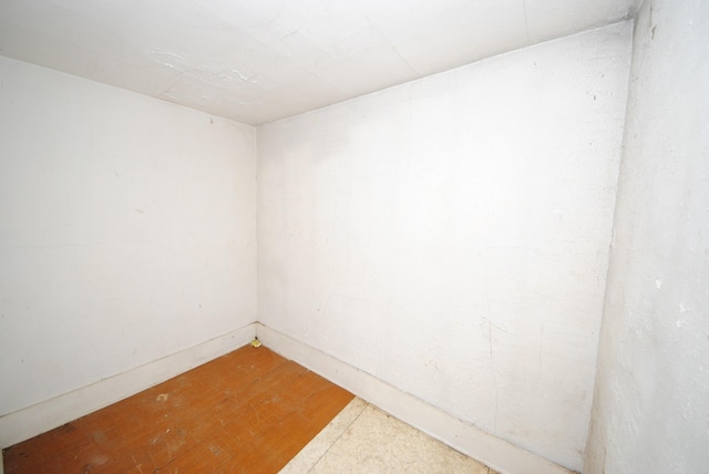 empty room with hardwood / wood-style flooring