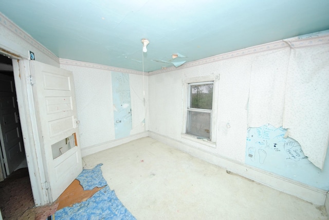 spare room featuring light colored carpet and ornamental molding