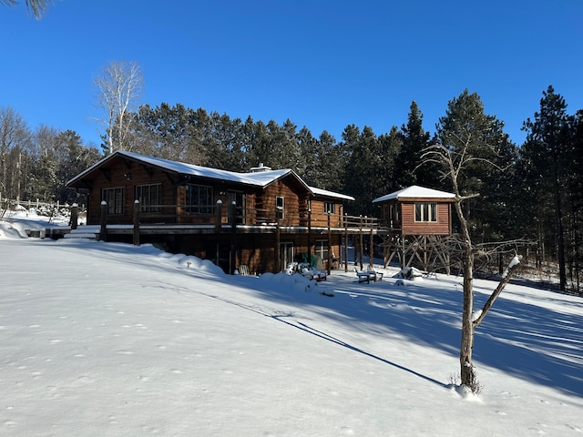 view of snow covered rear of property