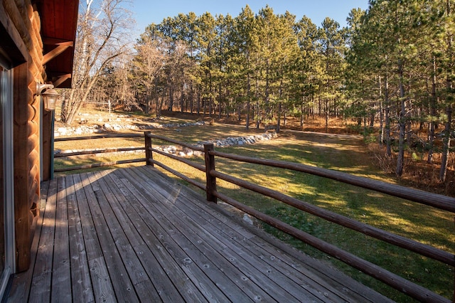 wooden terrace featuring a yard