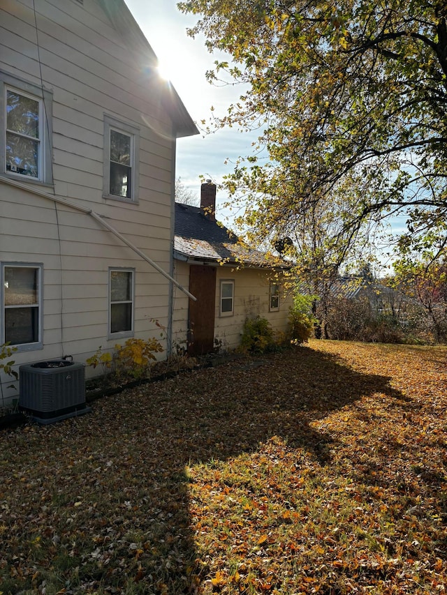 back of house featuring central air condition unit