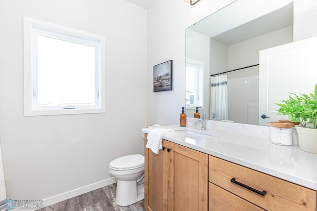 bathroom with walk in shower, vanity, toilet, and hardwood / wood-style flooring