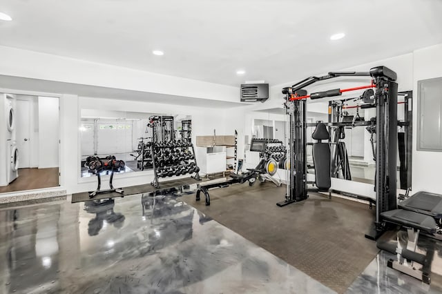 workout area featuring concrete flooring and washer / dryer