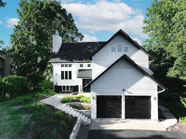 4756 Kildare Rd, Mound, MN 55364 - view of front of property featuring a chimney, roof with shingles, and driveway