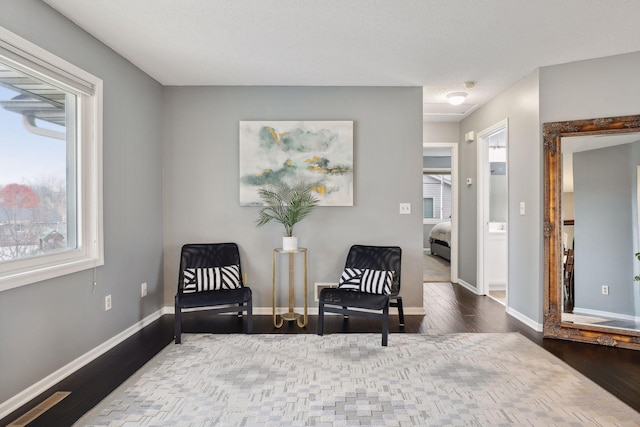 sitting room with hardwood / wood-style floors and a textured ceiling