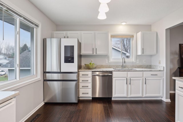 kitchen featuring white cabinets, plenty of natural light, and appliances with stainless steel finishes