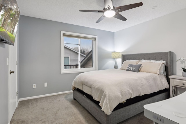 carpeted bedroom with a textured ceiling and ceiling fan