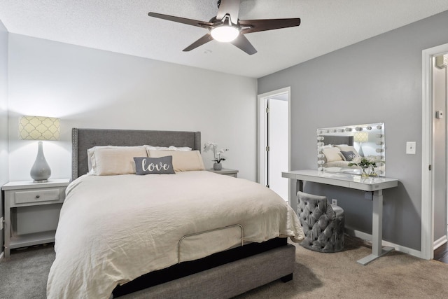 bedroom with a textured ceiling, carpet floors, and ceiling fan