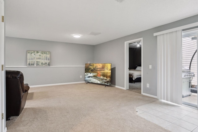 sitting room featuring ceiling fan and light carpet