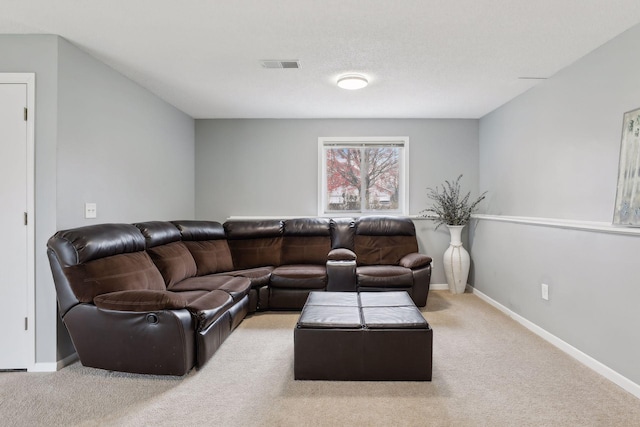 carpeted living room featuring a textured ceiling