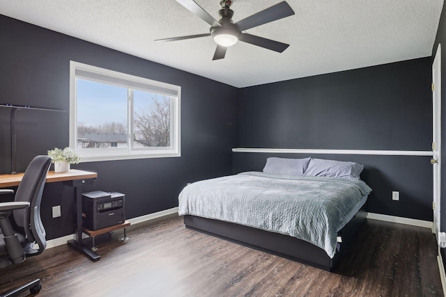 bedroom with a textured ceiling, dark hardwood / wood-style floors, and ceiling fan