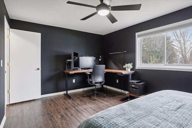 bedroom featuring a textured ceiling, ceiling fan, and dark wood-type flooring