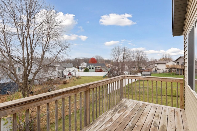 wooden deck featuring a yard