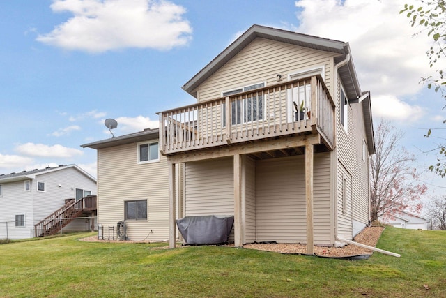 rear view of house with a yard and a deck