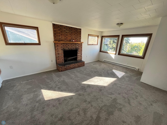 unfurnished living room featuring a baseboard radiator, dark carpet, and a brick fireplace