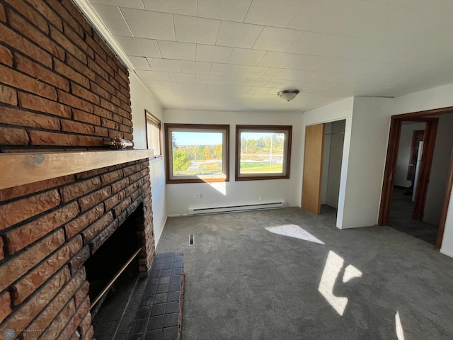 unfurnished living room featuring a fireplace, dark colored carpet, and a baseboard heating unit