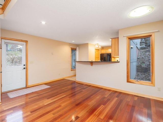 unfurnished living room featuring light hardwood / wood-style floors