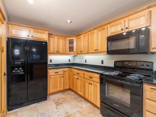 kitchen featuring black appliances and a textured ceiling