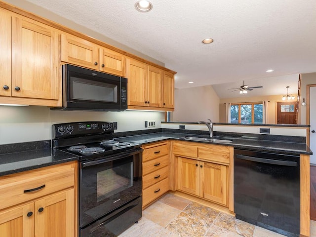 kitchen with black appliances, sink, vaulted ceiling, ceiling fan, and dark stone countertops