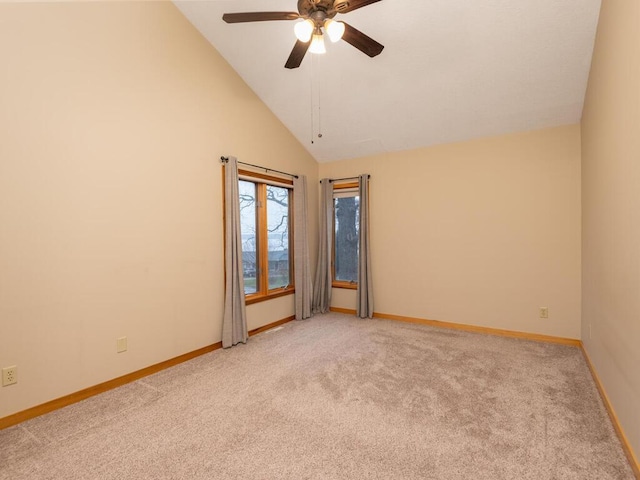 carpeted spare room featuring ceiling fan and high vaulted ceiling