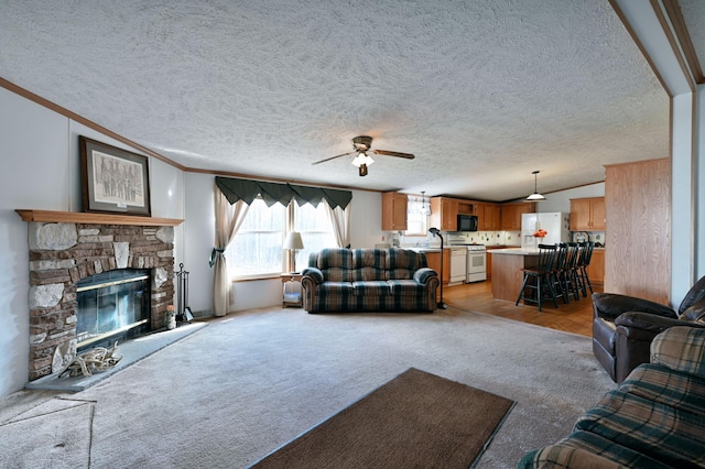 11242 Pierce Rd, Solon Springs, WI 54873 - living area with ceiling fan, crown molding, light colored carpet, a stone fireplace, and a textured ceiling
