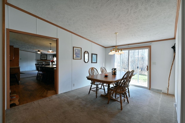 dining room featuring dark colored carpet, a textured ceiling, vaulted ceiling, and crown molding