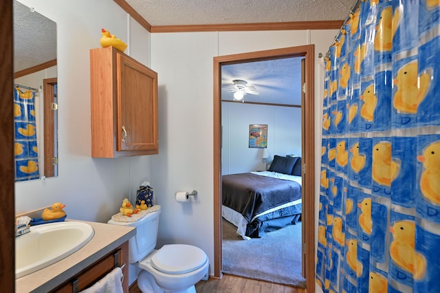 bathroom with a textured ceiling, hardwood / wood-style flooring, crown molding, and lofted ceiling