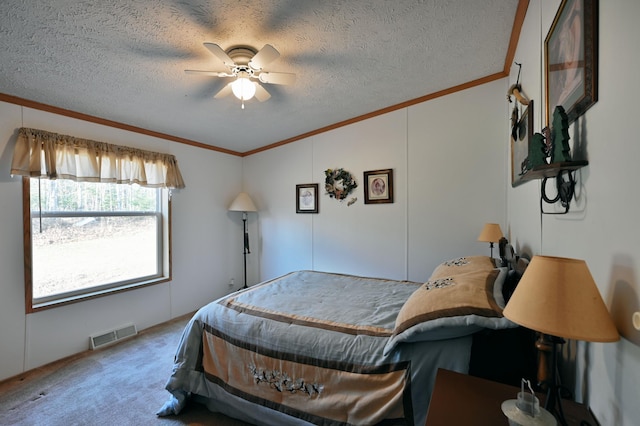 carpeted bedroom with ceiling fan, a textured ceiling, and ornamental molding