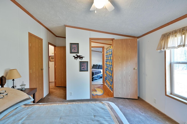 carpeted bedroom with a textured ceiling, ceiling fan, crown molding, and lofted ceiling