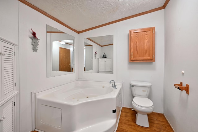 11242 Pierce Rd, Solon Springs, WI 54873 - full bath featuring crown molding, a textured ceiling, wood finished floors, a whirlpool tub, and toilet