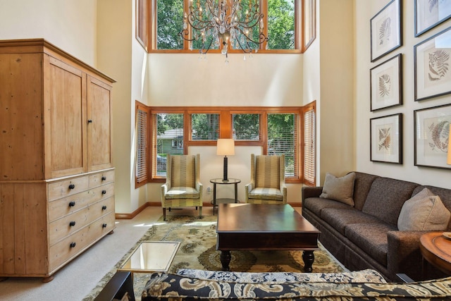 5006 Sheridan Ave S, Minneapolis, MN 55410 - carpeted living area featuring a high ceiling, healthy amount of natural light, a chandelier, and baseboards