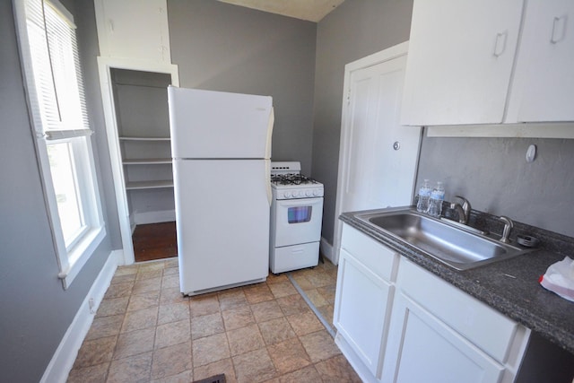 107 3rd Ave SW, Austin, MN 55912 - kitchen featuring white cabinetry, sink, and white appliances