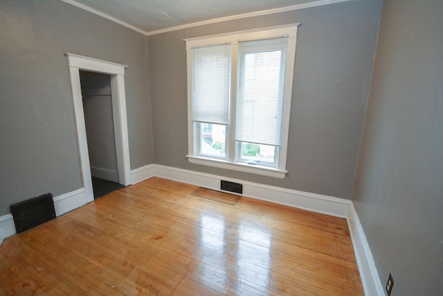 107 3rd Ave SW, Austin, MN 55912 - unfurnished bedroom featuring light hardwood / wood-style flooring, multiple windows, and crown molding