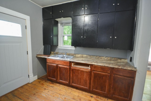107 3rd Ave SW, Austin, MN 55912 - kitchen featuring sink and light wood-type flooring