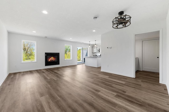 unfurnished living room with dark hardwood / wood-style floors