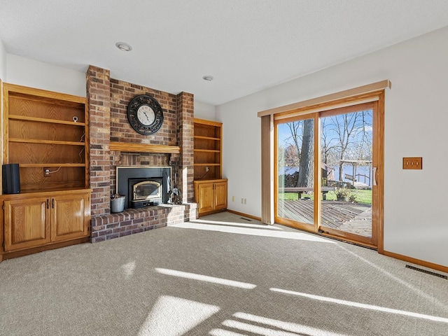 unfurnished living room with carpet flooring and a wood stove