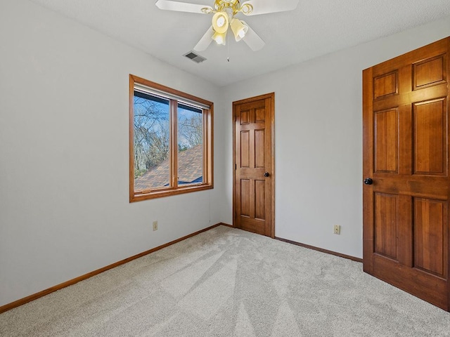 unfurnished bedroom with light carpet and ceiling fan