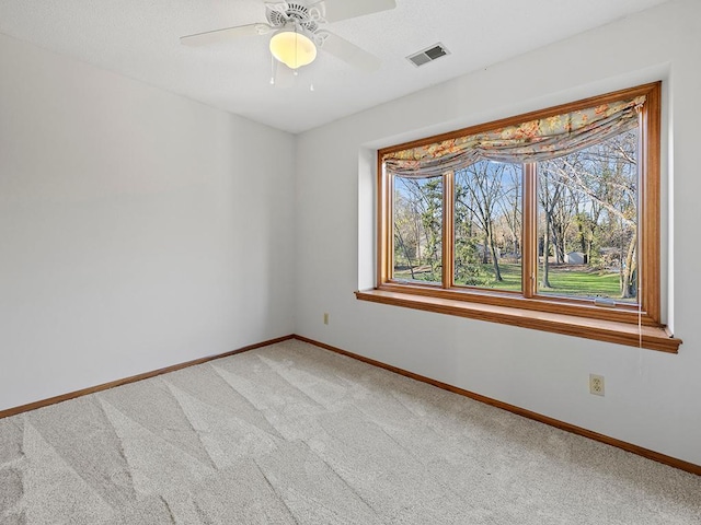 unfurnished room featuring carpet and ceiling fan