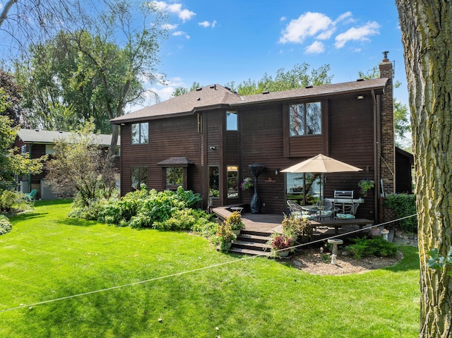 back of property featuring a yard and a deck