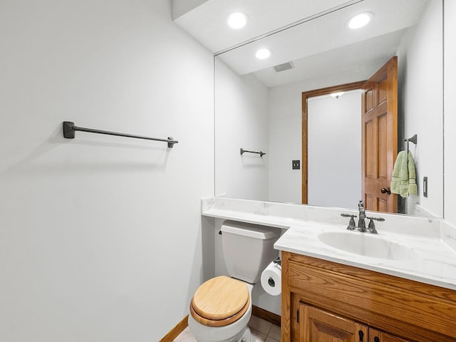 bathroom featuring tile patterned floors, vanity, and toilet