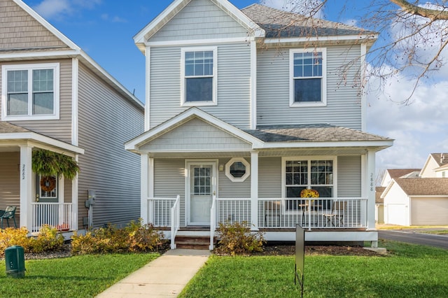 view of front of property with covered porch and a front lawn