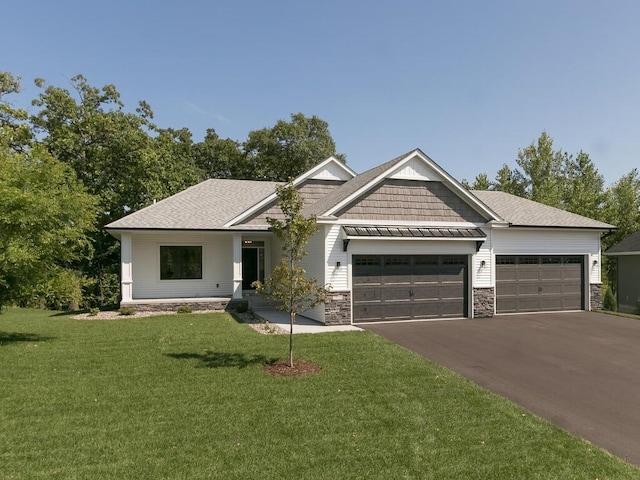 view of front of house with a garage and a front lawn