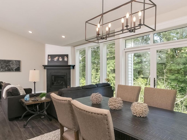 dining area with dark hardwood / wood-style flooring and a chandelier