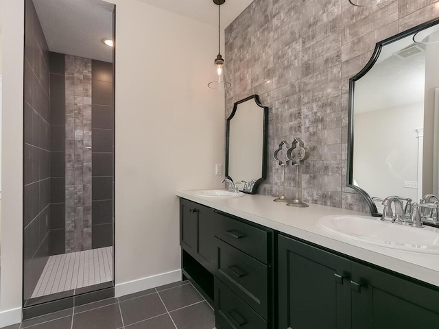 bathroom featuring tile patterned flooring, vanity, and tile walls