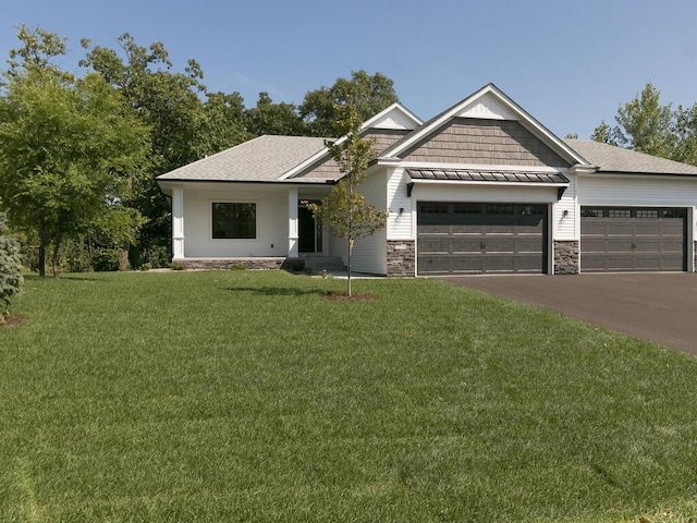 view of front of house featuring a garage and a front lawn