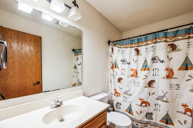 bathroom featuring vanity, toilet, a textured ceiling, and walk in shower